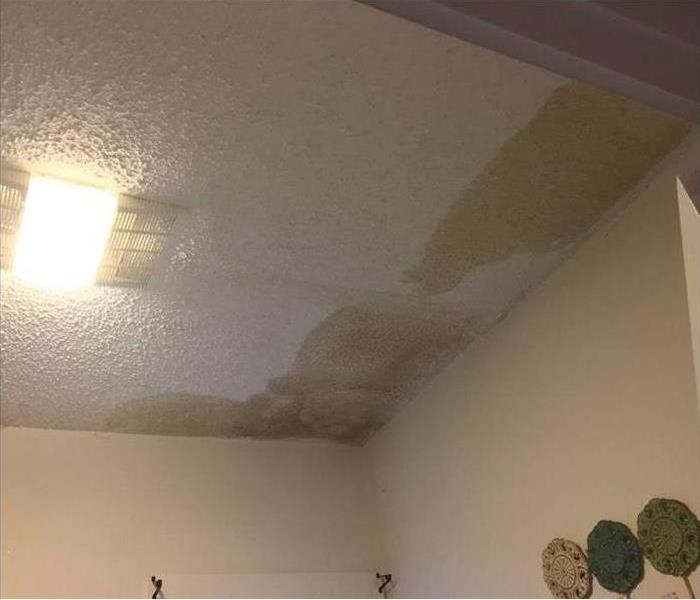 water stains on ceiling by corner