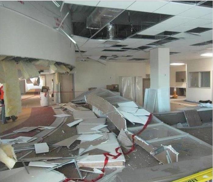 ceiling tiles on ground, damaged ceiling visible