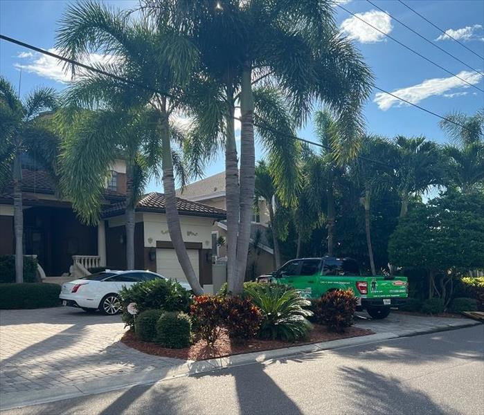 servpro truck parked at house, palm trees